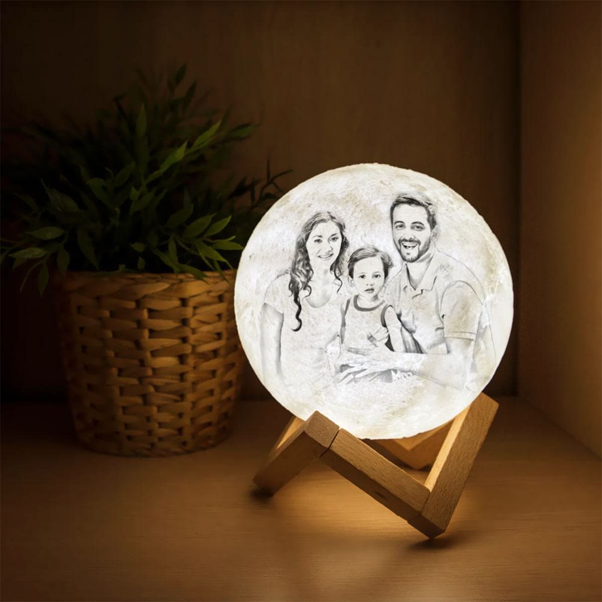 White color lamp with family painting on it placed on a wooden stand on a wooden table